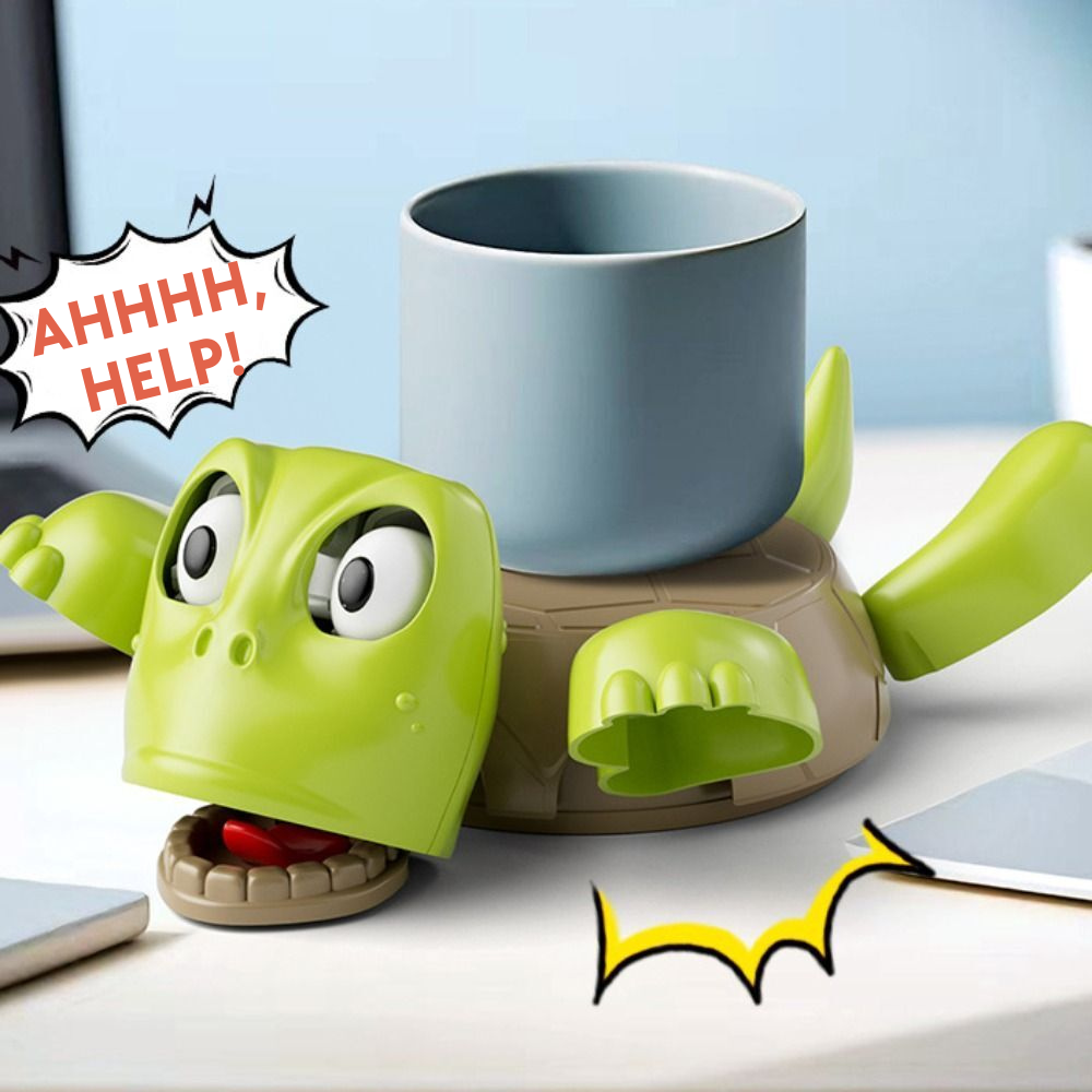 Green turtle coaster with a distressed expression next to a blue mug on a light blue background