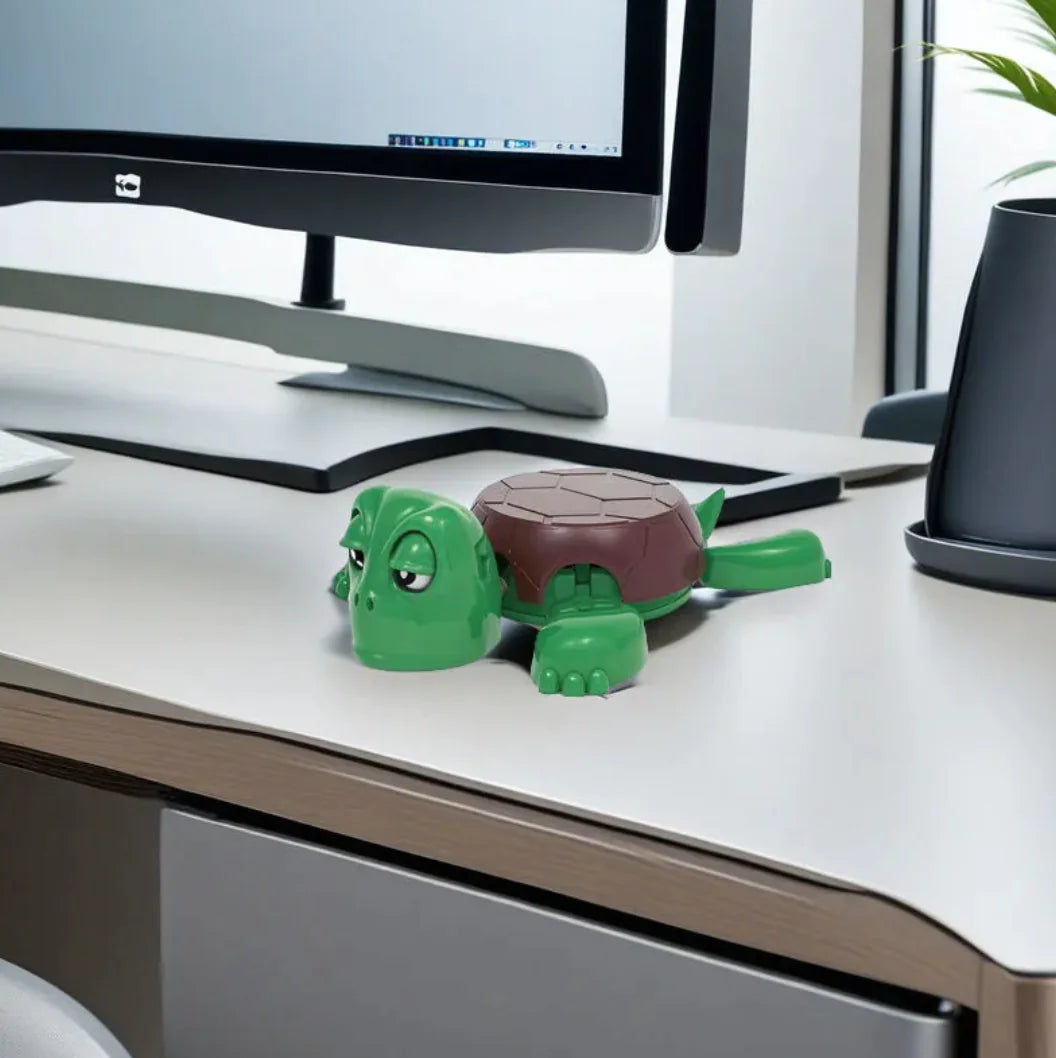 green brown turtle coaster on a desk with a computer monitor in the background